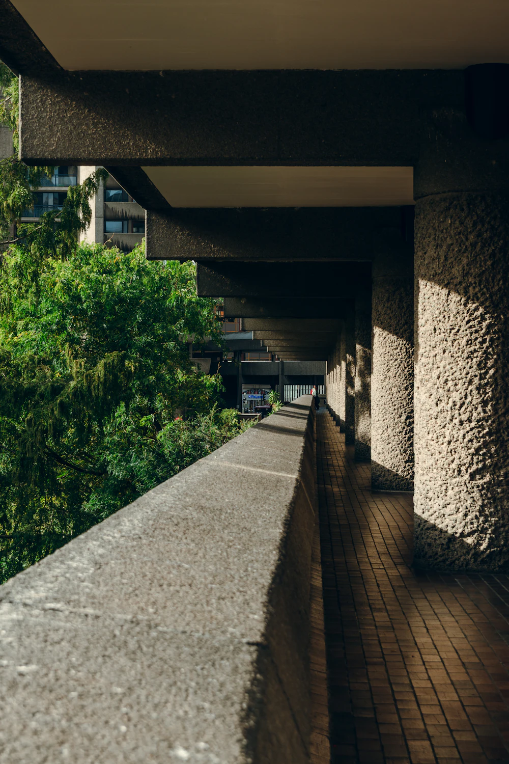 Sunlight across the concrete walkways of the Barbican, London